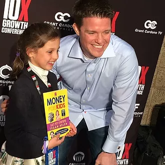 Tegan Helen with book, Money for Kids